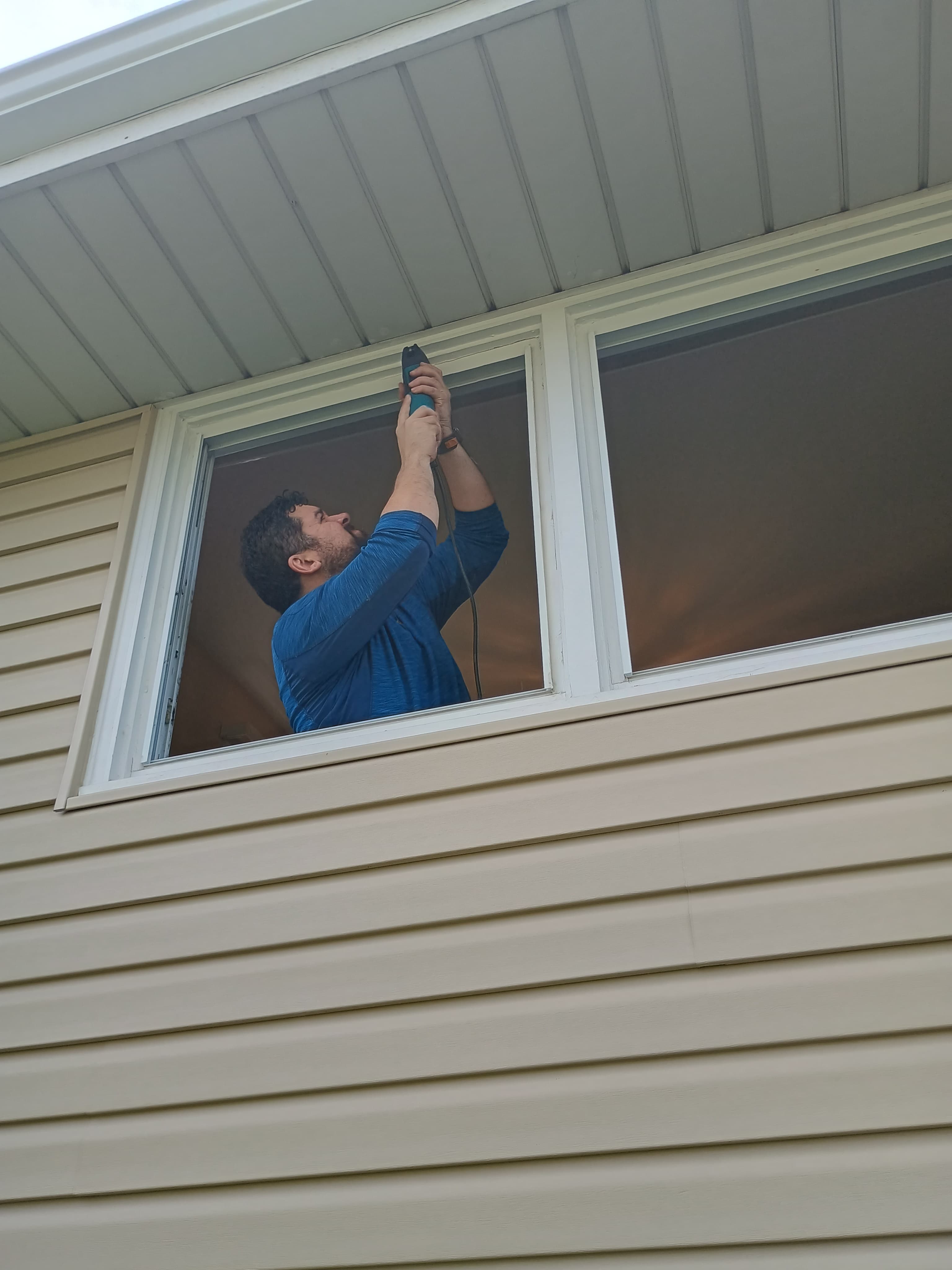 K Windows installer preparing a window opening for a proper fit
